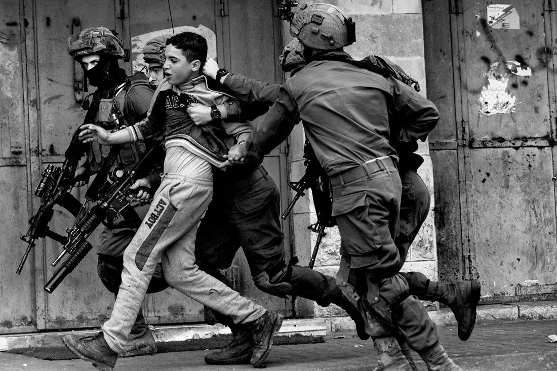 Israeli soldiers detaining a Palestinian during clashes at a protest, Hebron, West Bank, February 2018